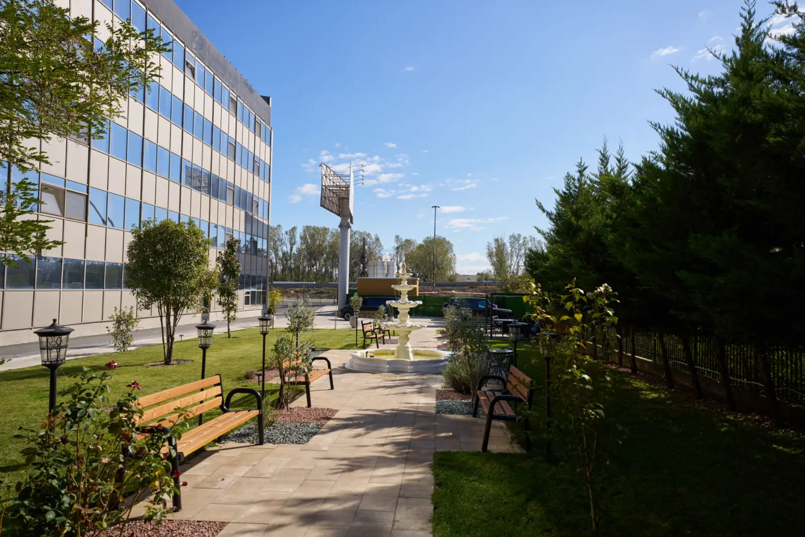Grădină amenajată cu fântână arteziană albă, bănci din lemn, lanterne decorative, AsertivO Otopeni